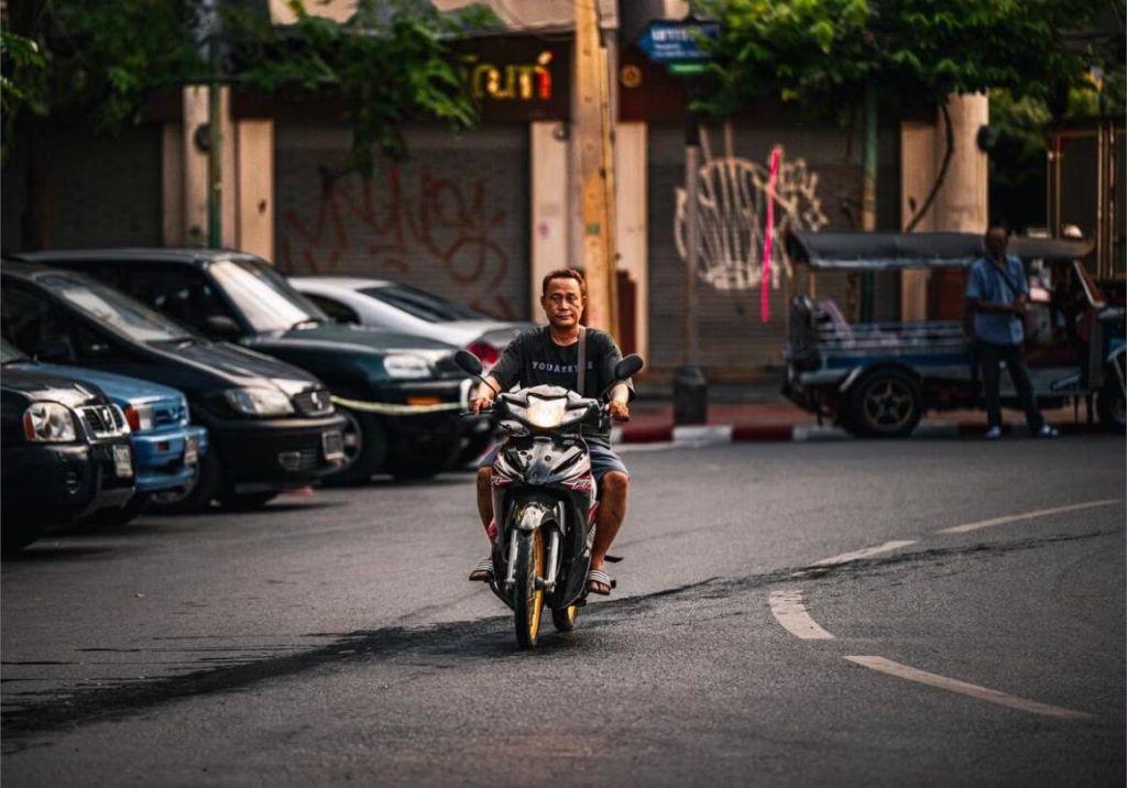Rider on a rental scooter on a Chiang Mai street