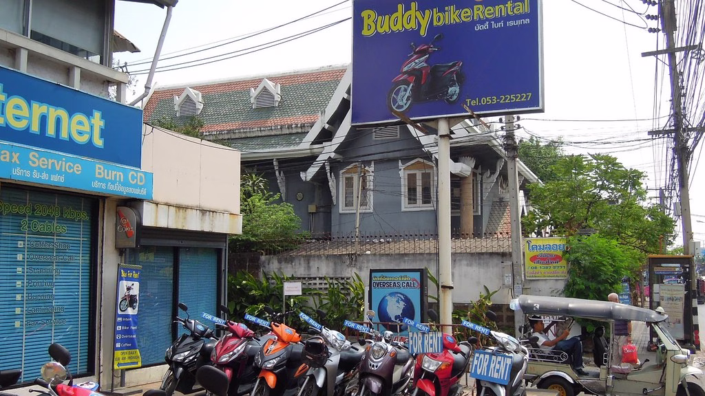 Rental scooters lined up outside a shop in Chiang Mai, ready for a pre-rental inspection