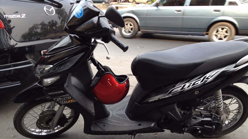Honda Click automatic scooter parked outside a rental shop in Chiang Mai